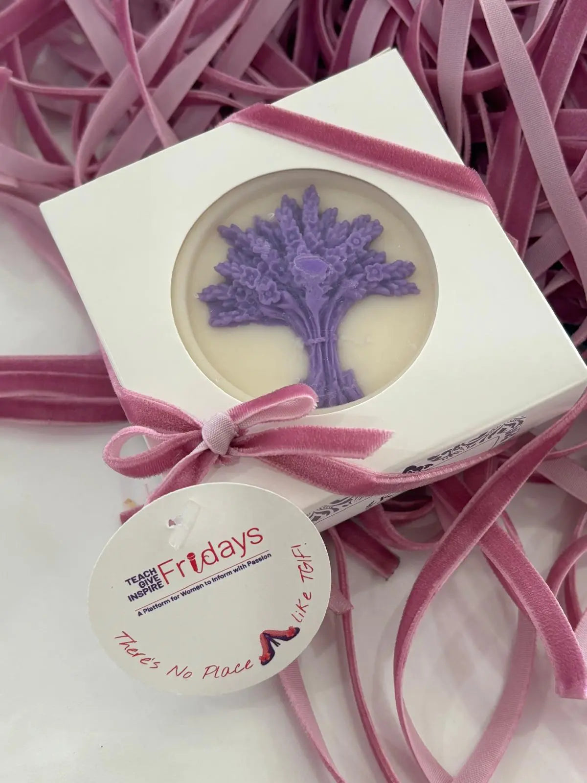 Soap with lavender design in a decorative box with pink ribbon on a pink background