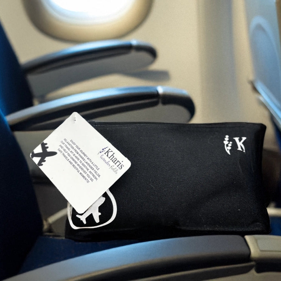Black travel pillow with a tag on an airplane seat